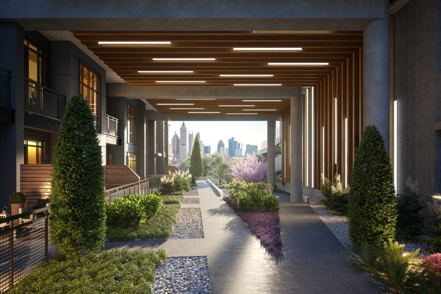 Modern apartment building entrance featuring a walkway lined with trees, creating a welcoming atmosphere.