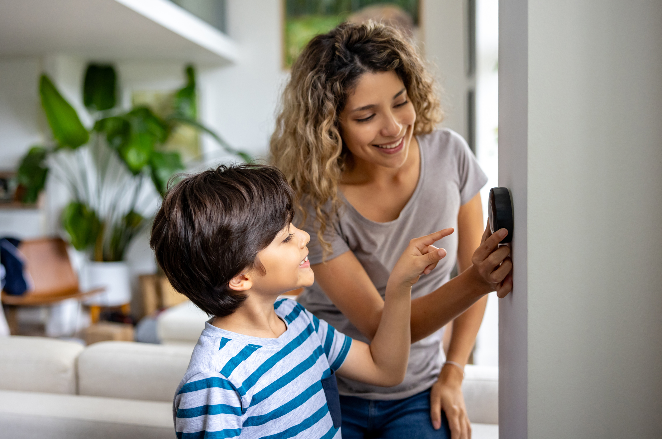 A mother and child having a joyful conversation, both smiling and engaged in a warm exchange.