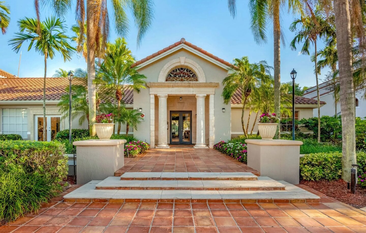 a building with palm trees and steps