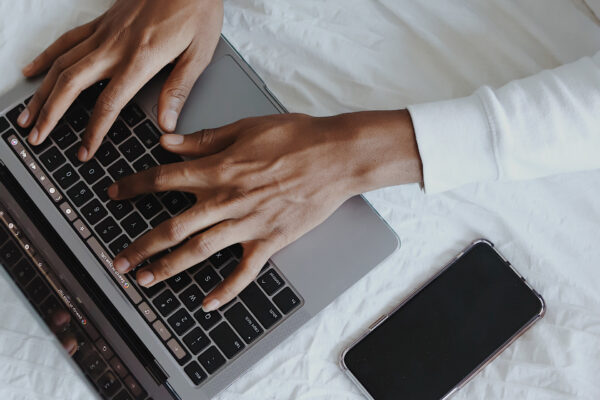 hands typing on a laptop