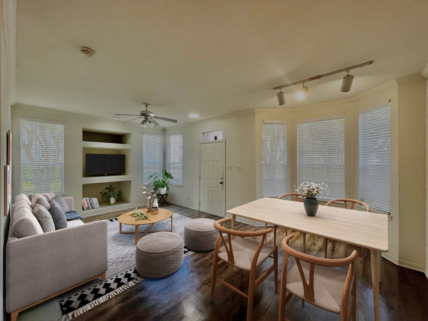 a living room and dining room with a table and chairs