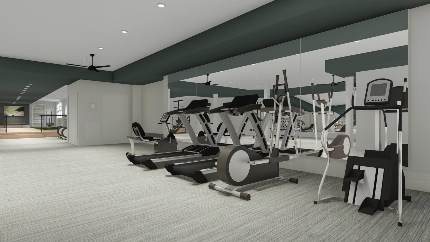 a gym with treadmills and other exercise equipment in a building with white walls