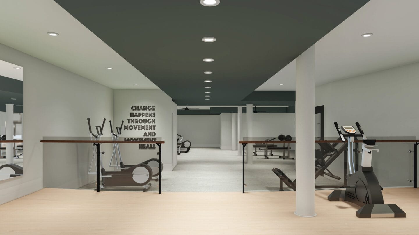 a gym with exercise machines and weights on a wooden floor