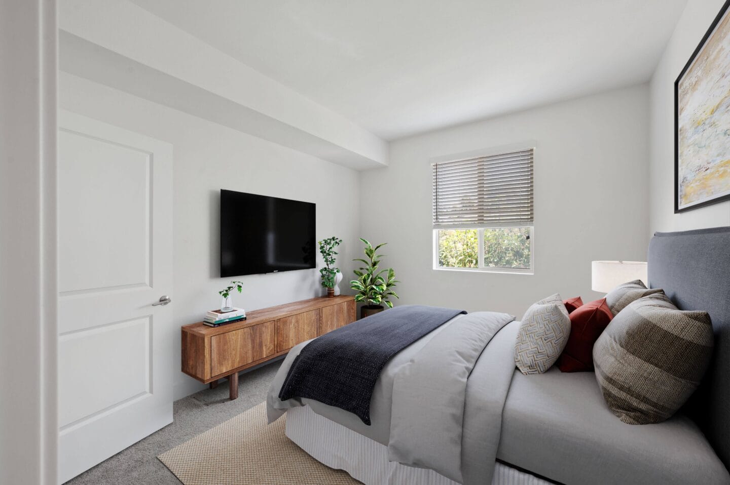 a bedroom with a bed and a tv on the wall