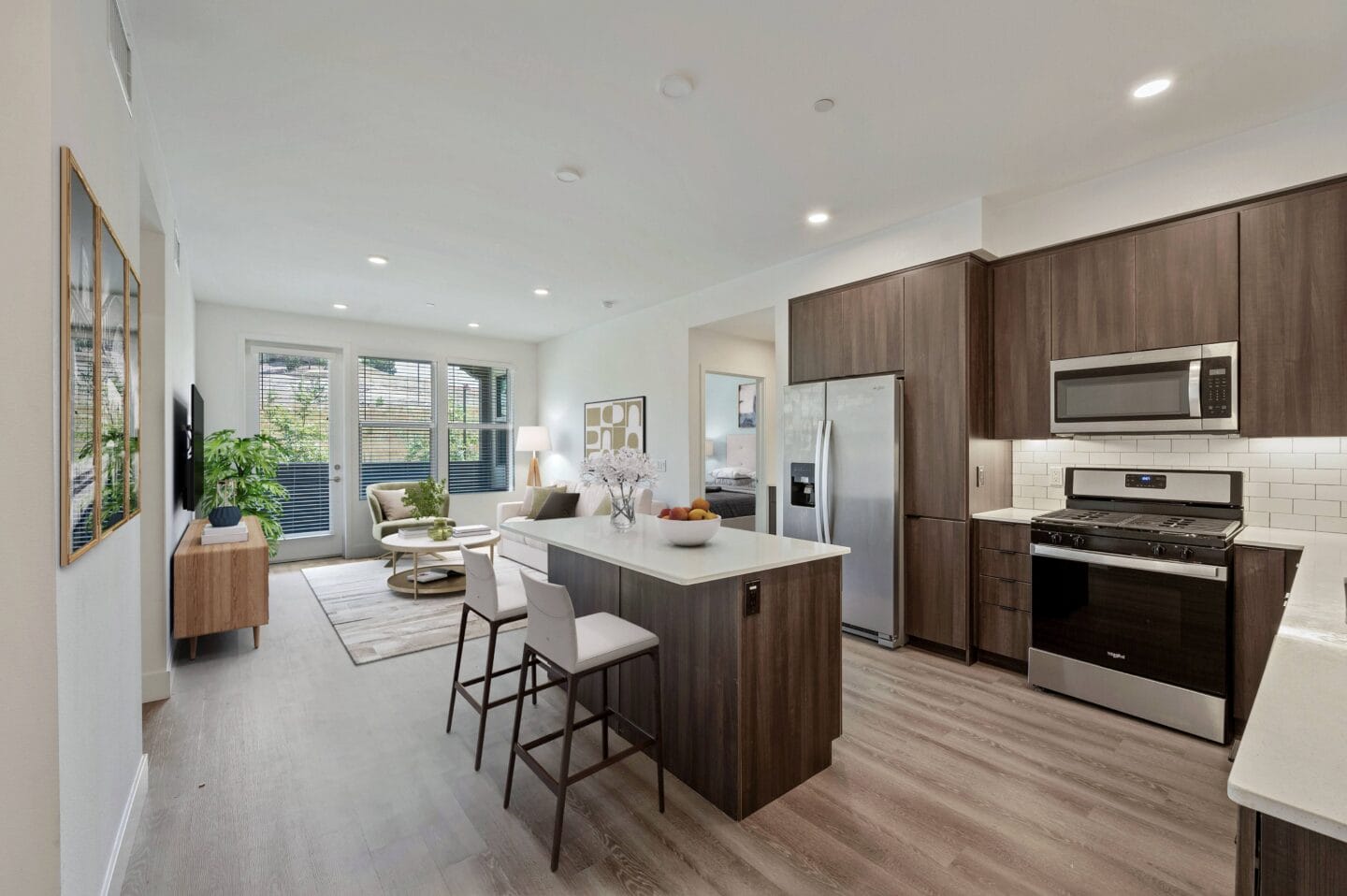 a kitchen and living room with a table and chairs