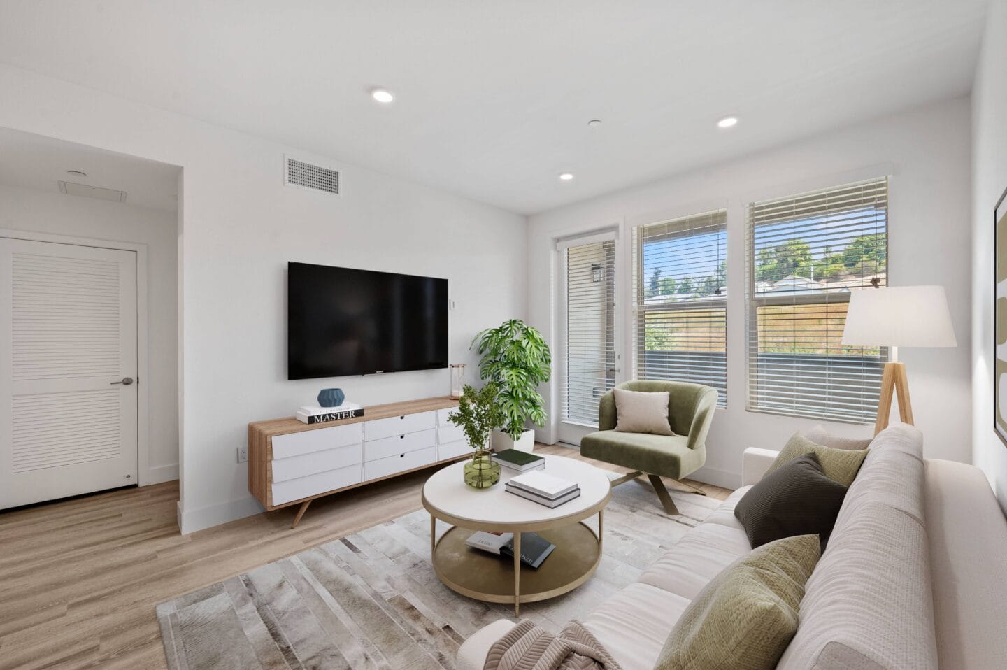 a view of a living room with a mirrored floor and a tree in therium