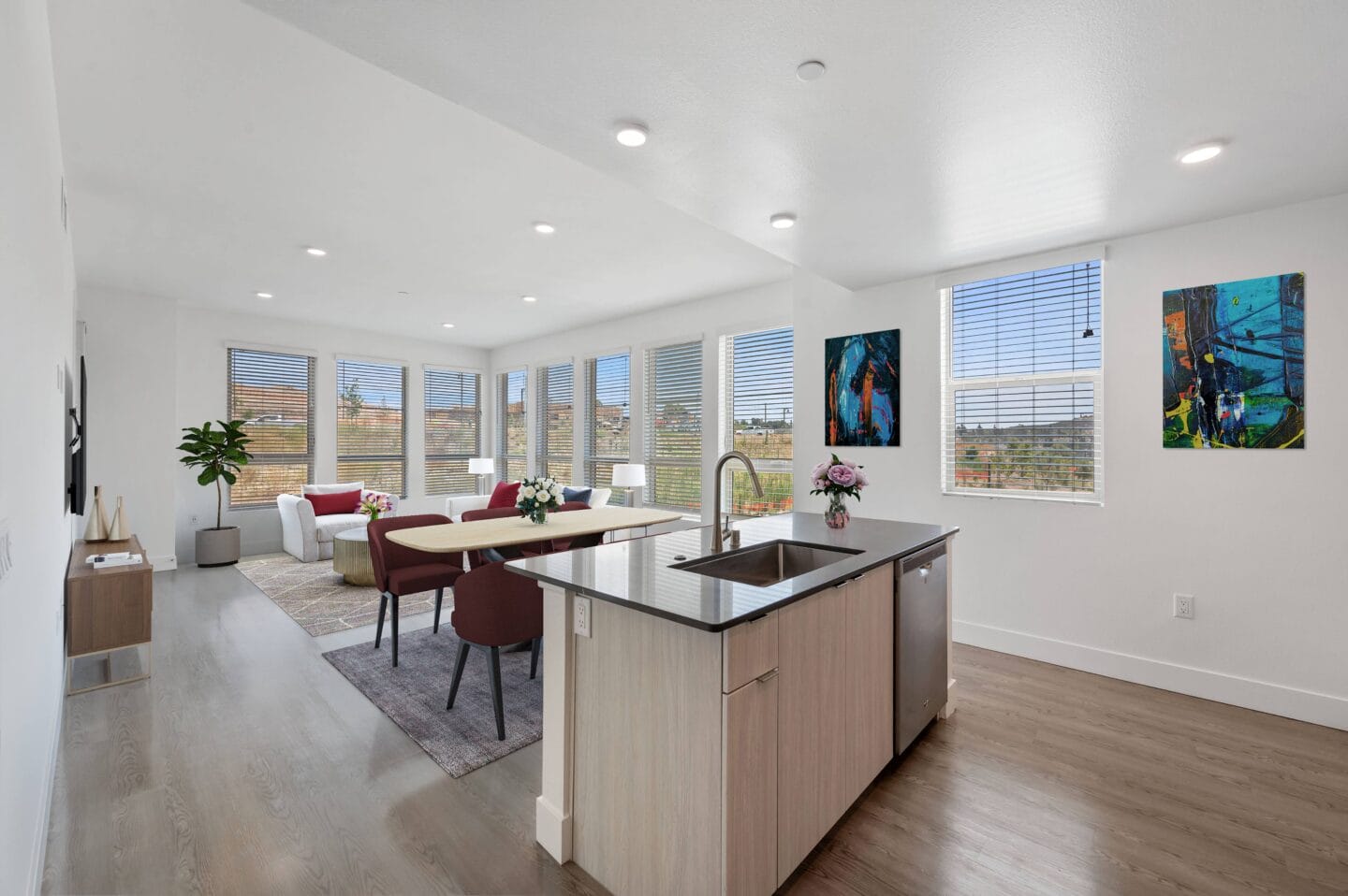 an open kitchen and living room with a table and chairs