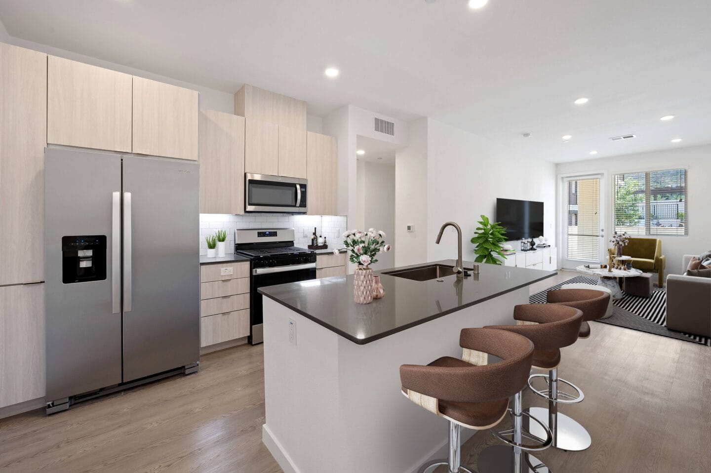 a kitchen with a large island with bar stools