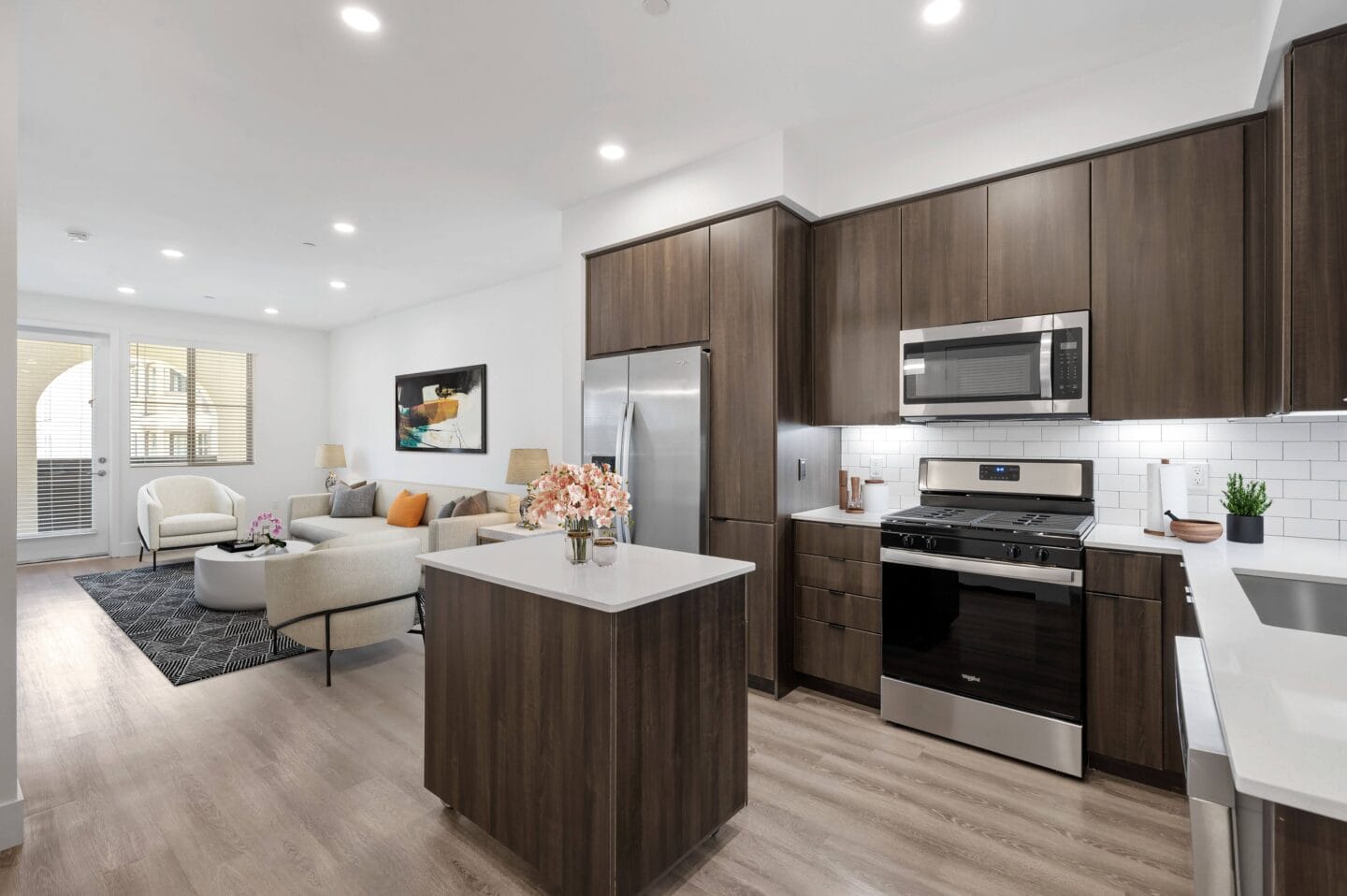 a living room with a kitchen and a table