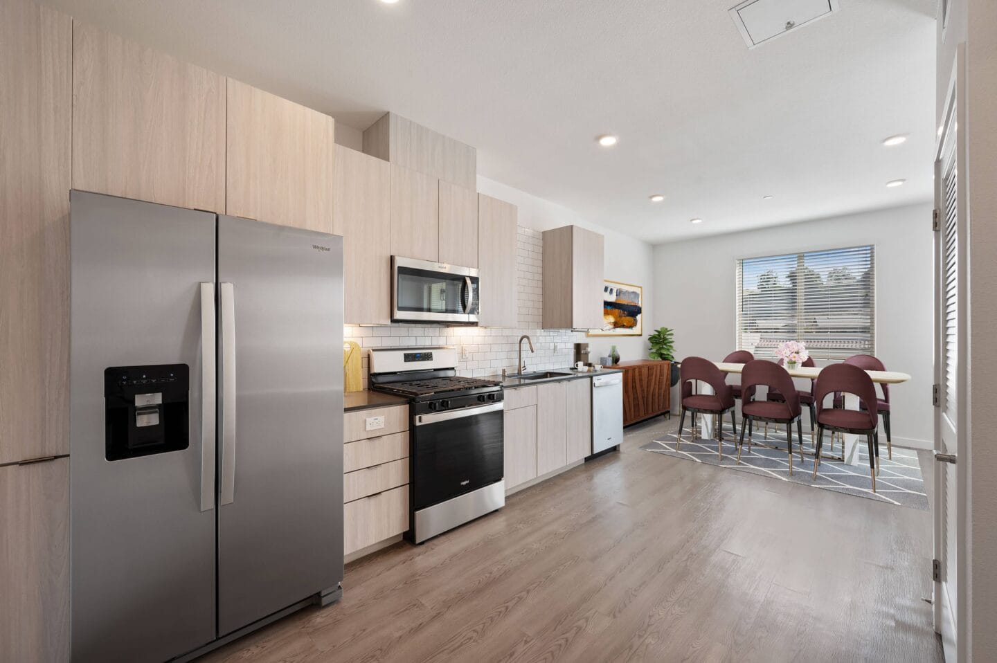 a kitchen with stainless steel appliances and a table and chairs