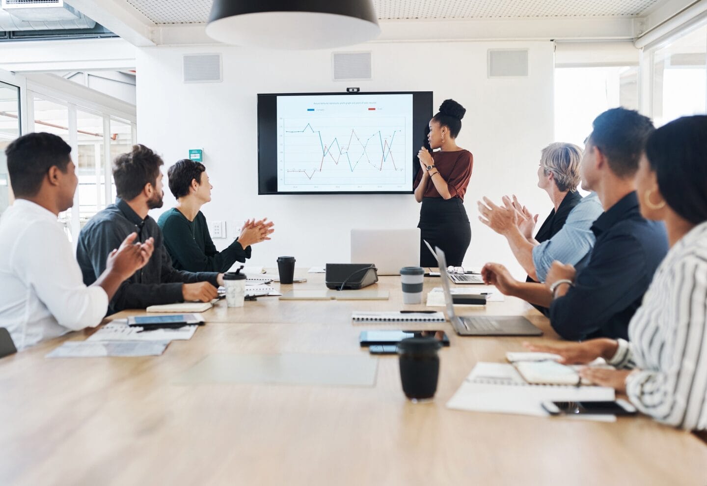 Shot of a group of business people clapping during a meeting in a modern office