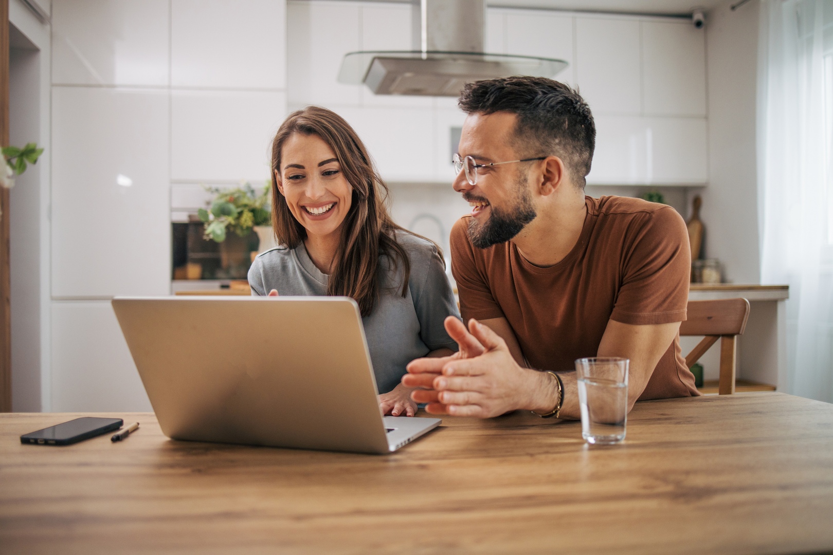 Adult couple using laptop computer at home.