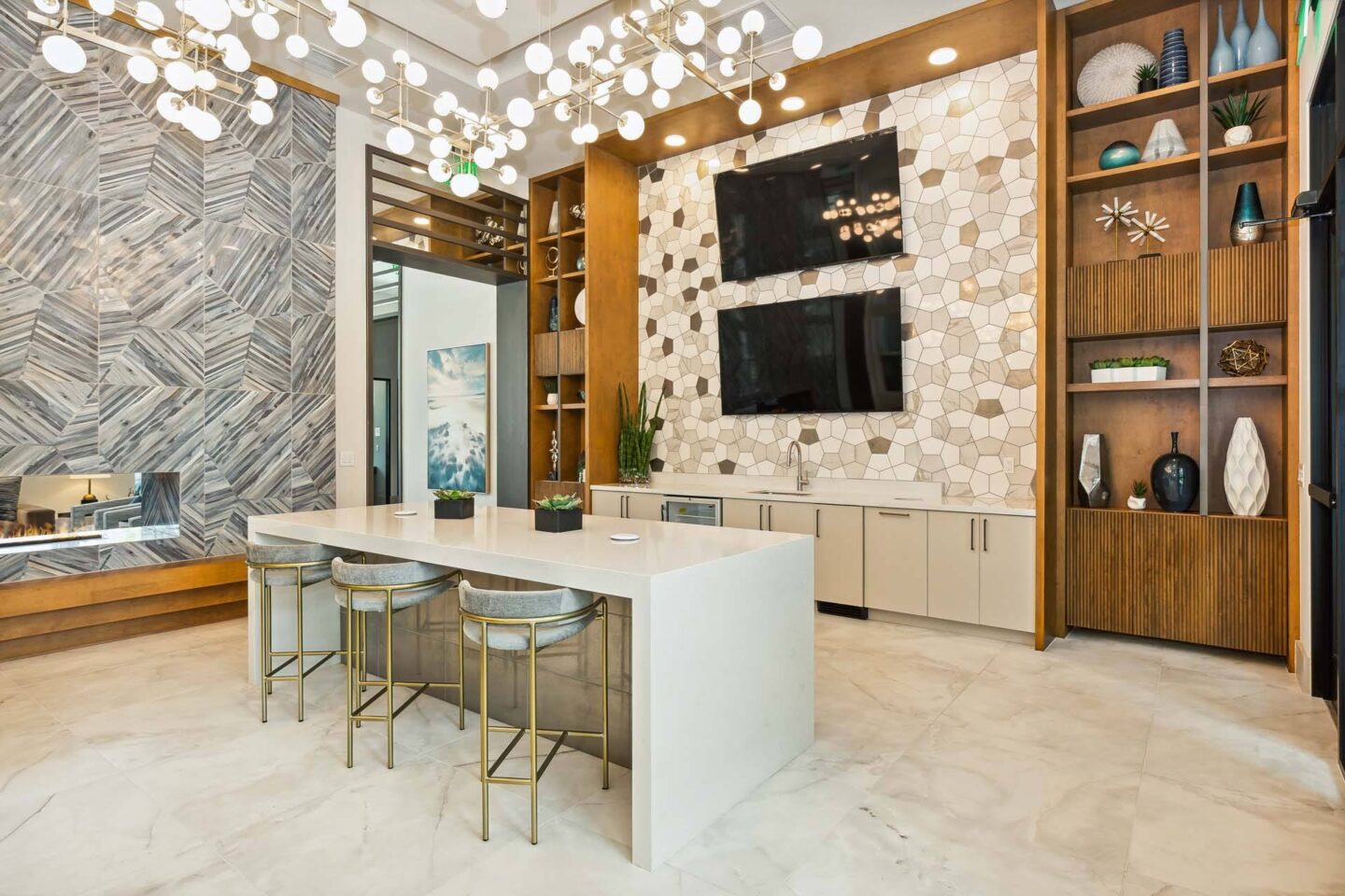 a kitchen with a white counter and chairs and a tv