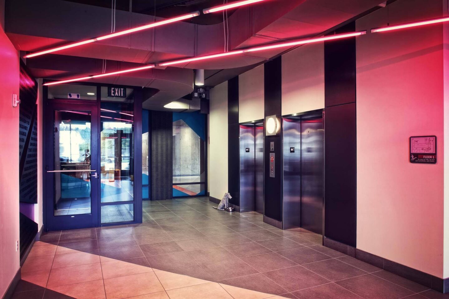 A hallway with a red light and a sign that says exit at Windsor Ballard, 5555 14th Ave NW, Seattle, WA