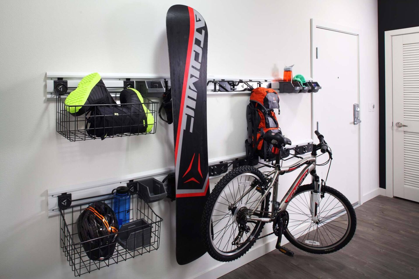 A bike is leaning against a wall with a snowboard hanging on the wall next to it at Windsor Ballard, 5555 14th Ave NW, Seattle, WA