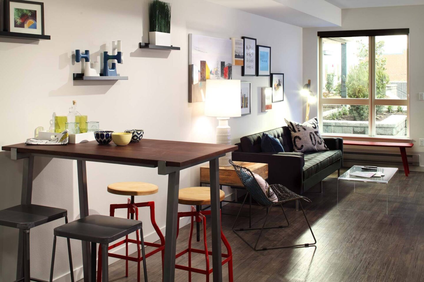 A modern living room with a wooden table and bar stools at Windsor Ballard, 5555 14th Ave NW, Seattle, WA