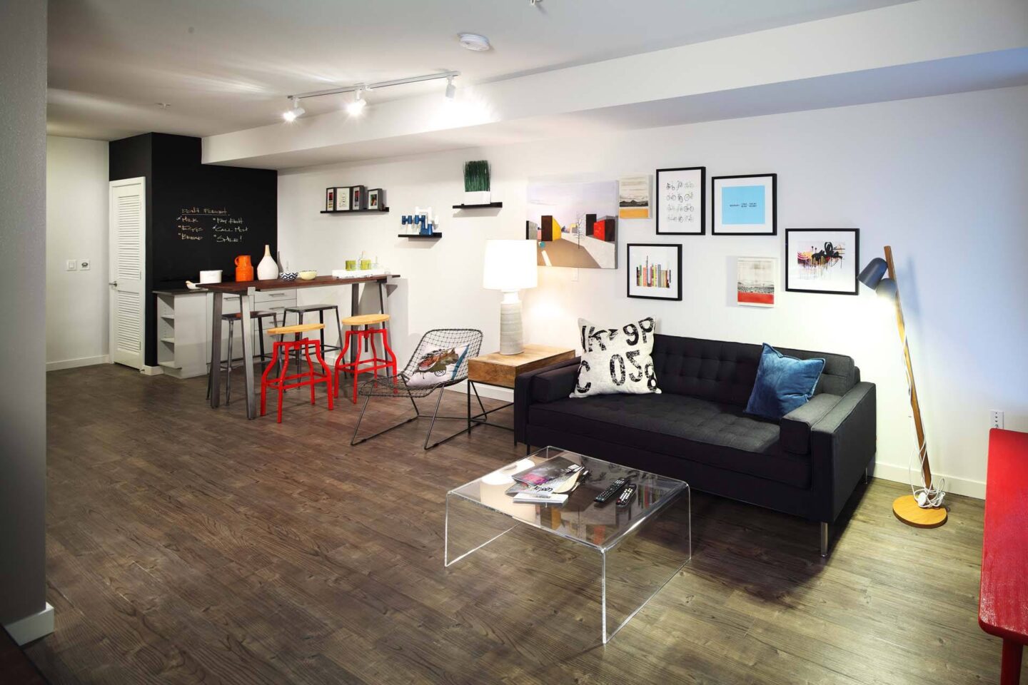 A living room with a black couch and a coffee table at Windsor Ballard, 5555 14th Ave NW, Seattle, WA