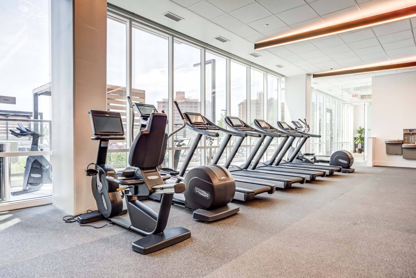 A row of treadmills and elliptical machines in a gym at Windsor North + Vine 633 W North Ave, Chicago, IL 60610.