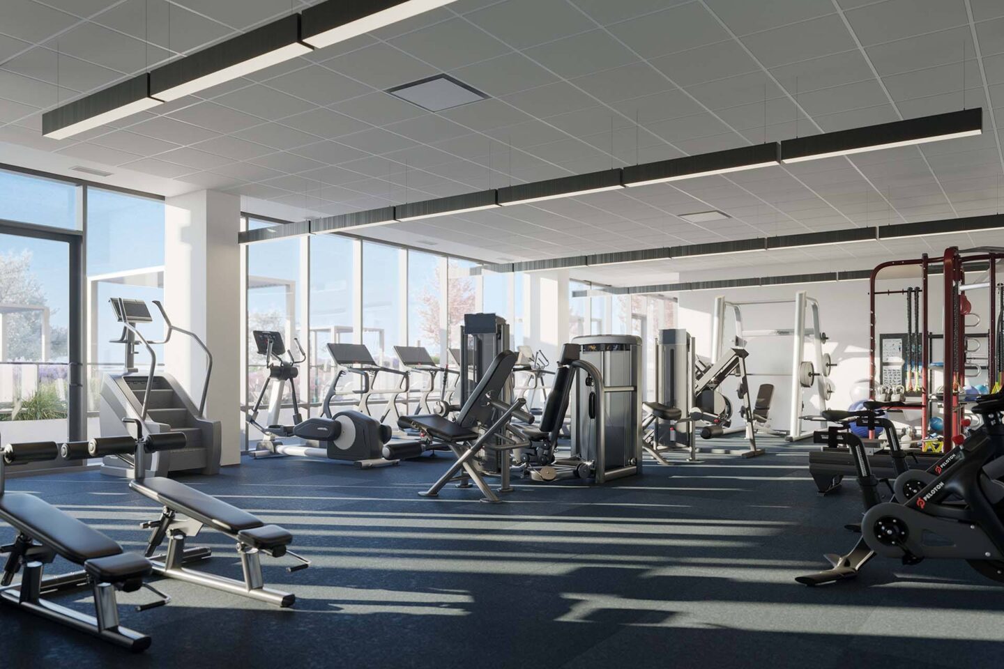 A gym with various exercise equipment and a large window at Windsor North + Vine 633 W North Ave, Chicago, IL 60610.