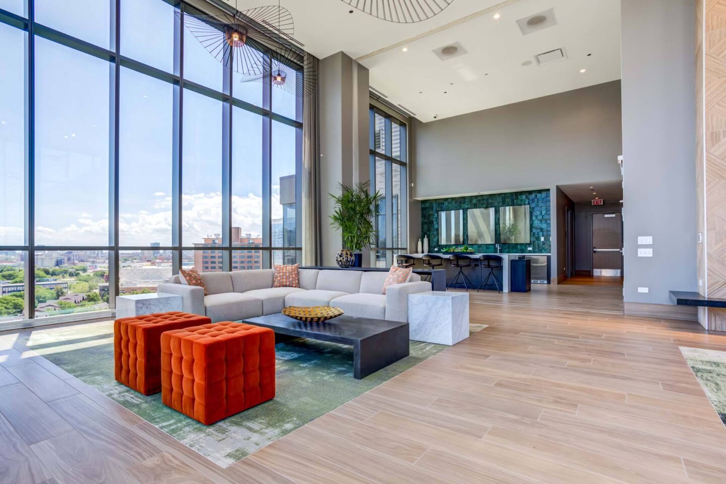 A lounge with a large window overlooking a cityscape at Windsor North + Vine 633 W North Ave, Chicago, IL 60610.