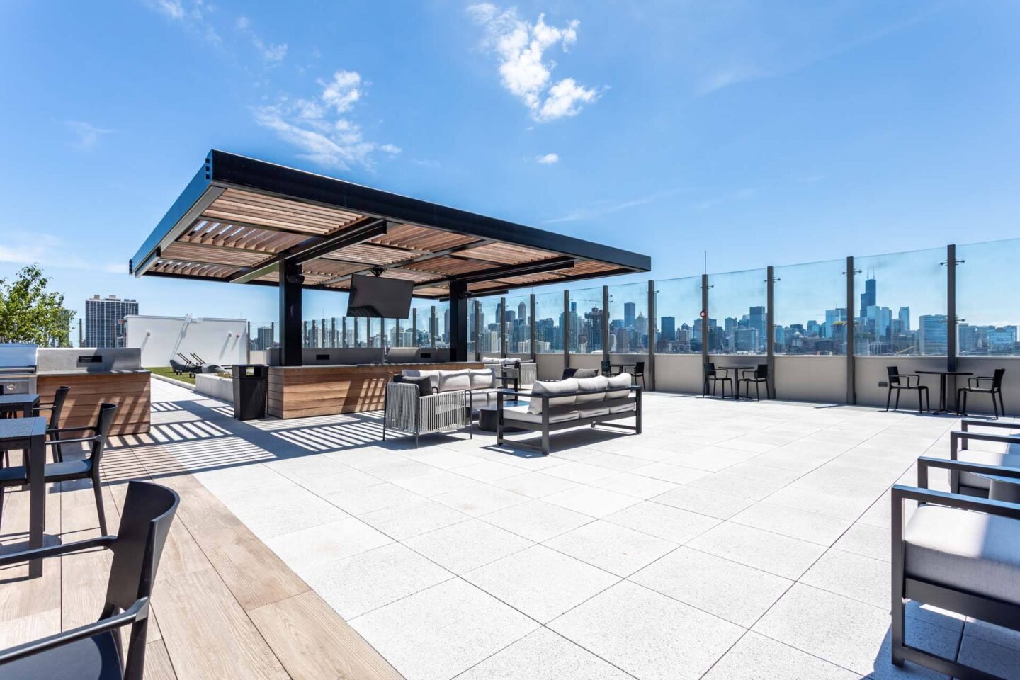 A rooftop patio with a view of the city skyline.