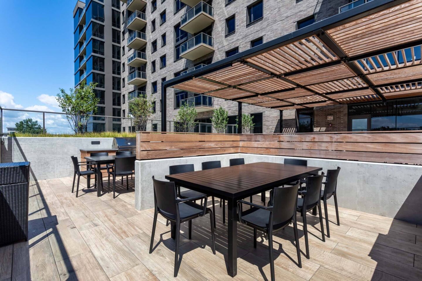 A wooden table with chairs is set up on a wooden deck.