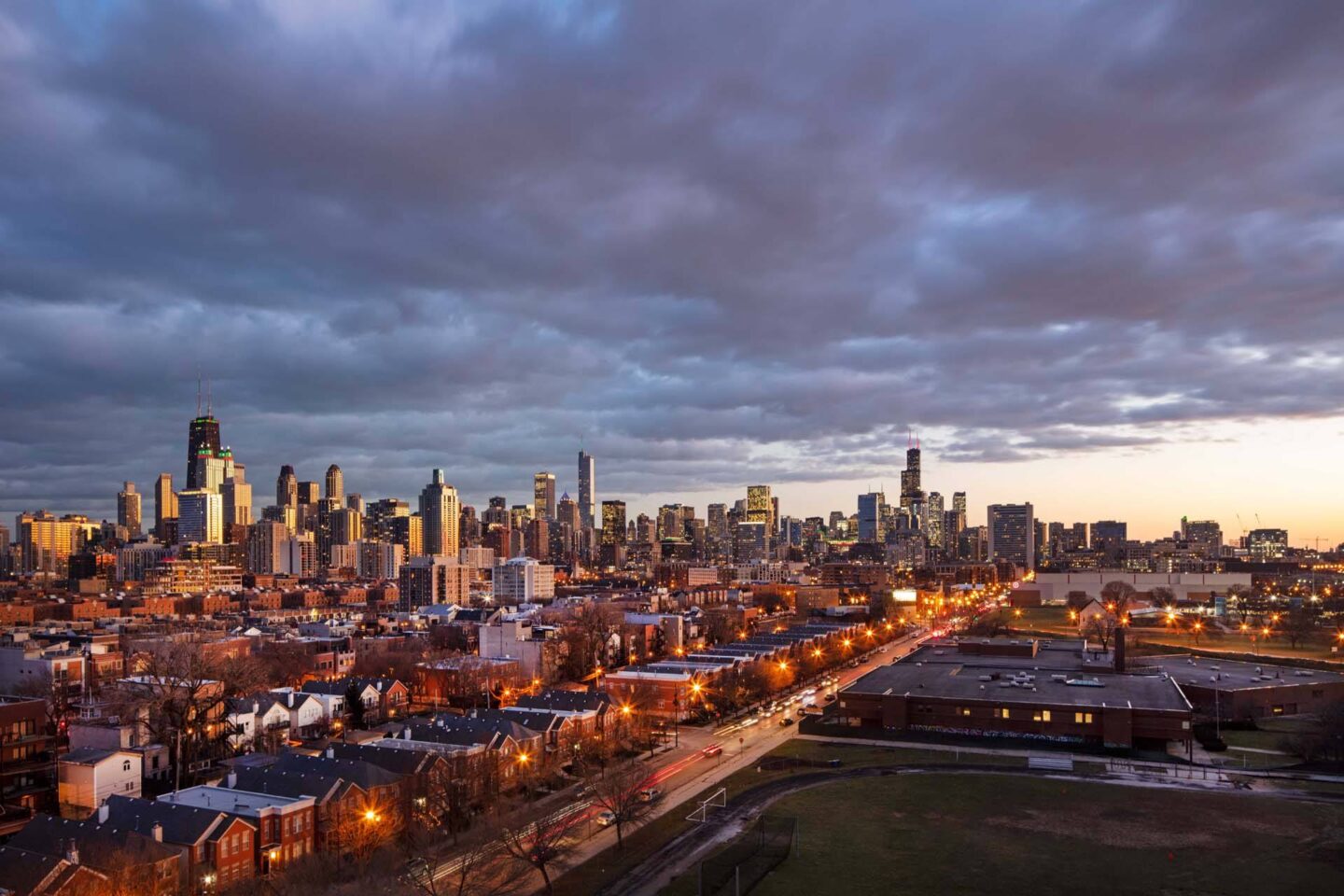 A cityscape with a mix of residential and commercial buildings under a cloudy sky at Windsor North + Vine 633 W North Ave, Chicago, IL 60610.