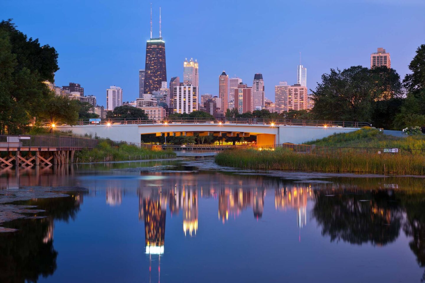 A city skyline is reflected in a body of water at Windsor North + Vine 633 W North Ave, Chicago, IL 60610..