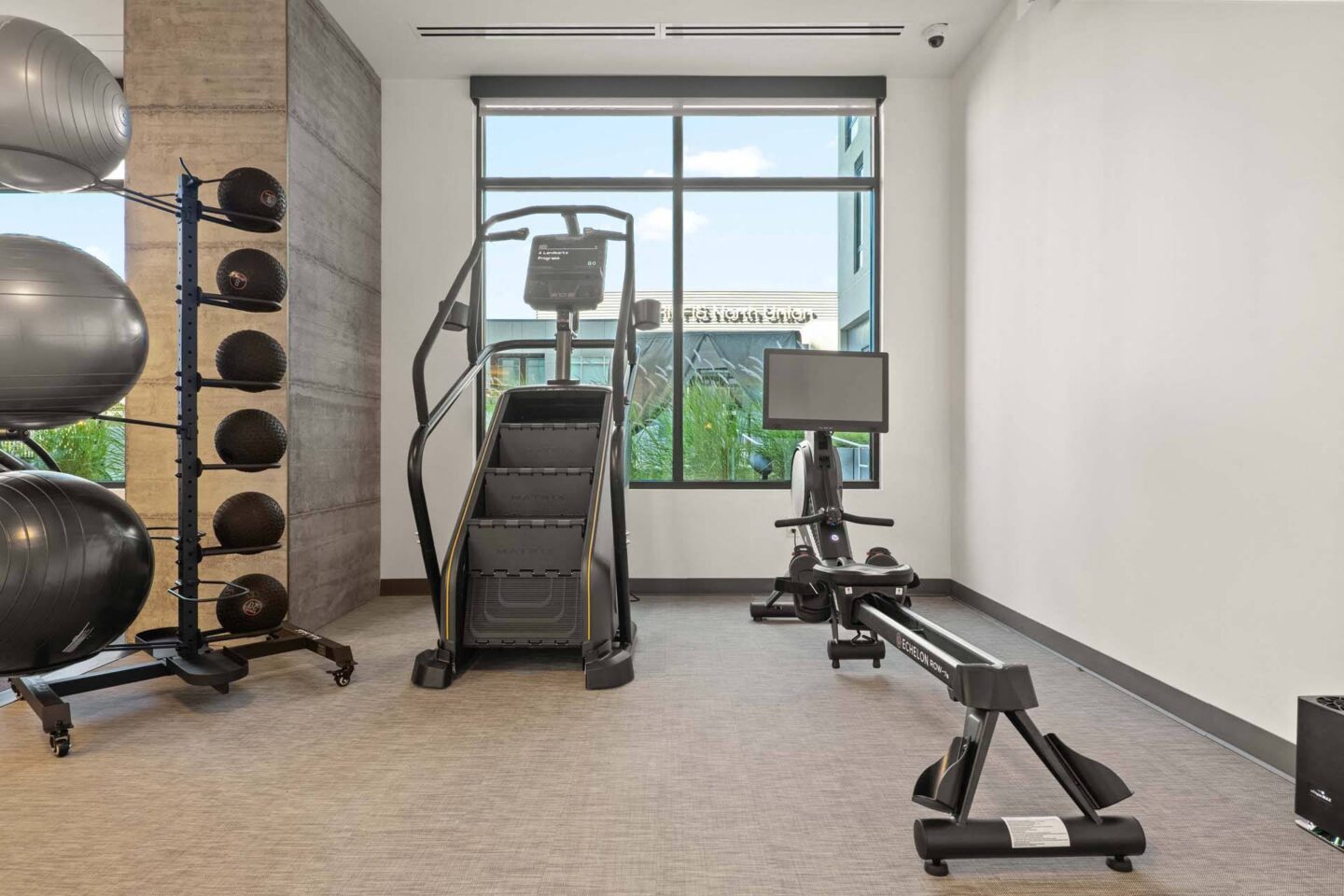 A fitness center with a variety of equipment including treadmills, weights, and exercise machines at Windsor 3000 Huron, 3000. N. Huron Street, Denver, CO 80202.