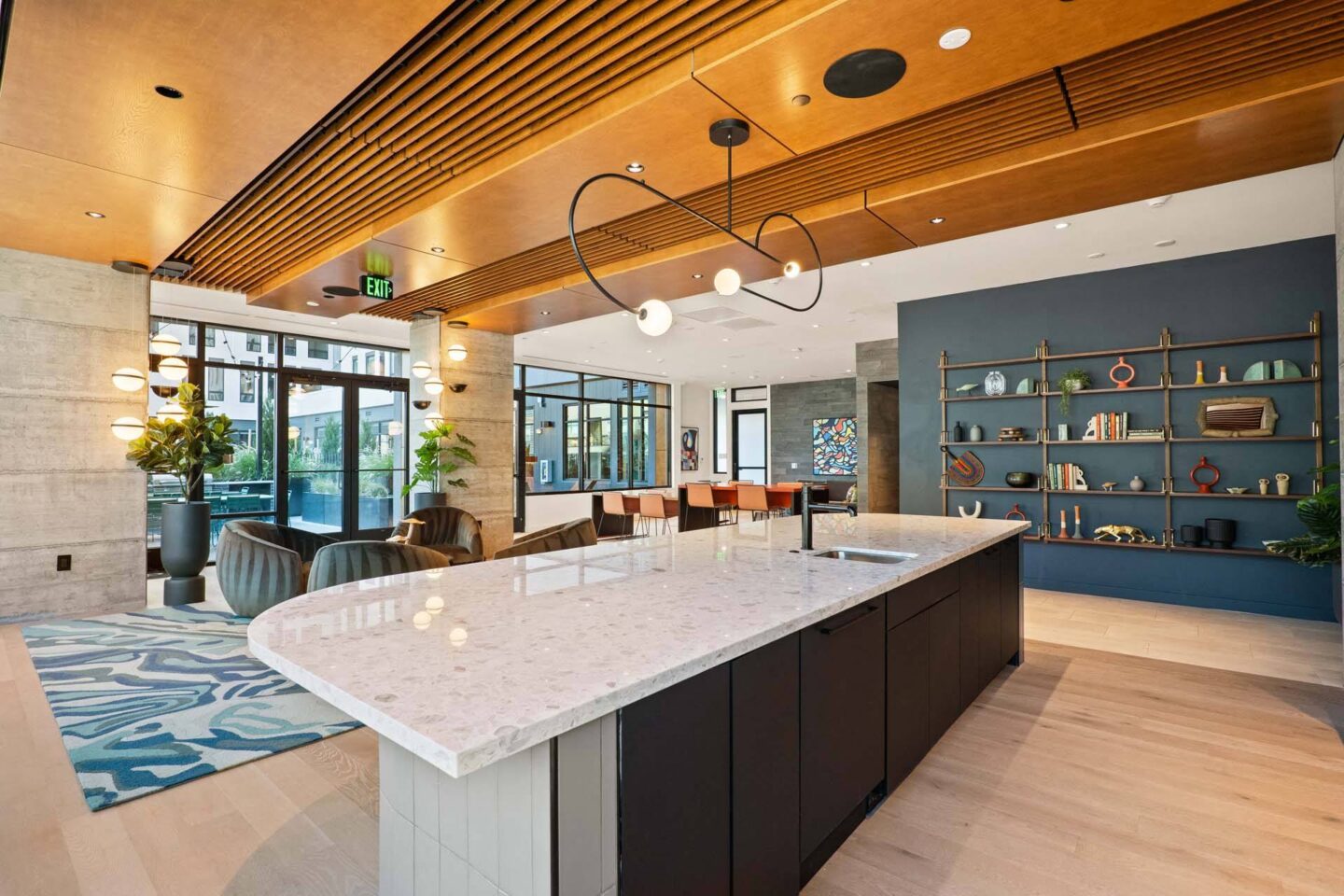 A modern lounge kitchen with a marble countertop and wooden cabinets  at Windsor 3000 Huron, 3000. N. Huron Street, Denver, CO 80202.