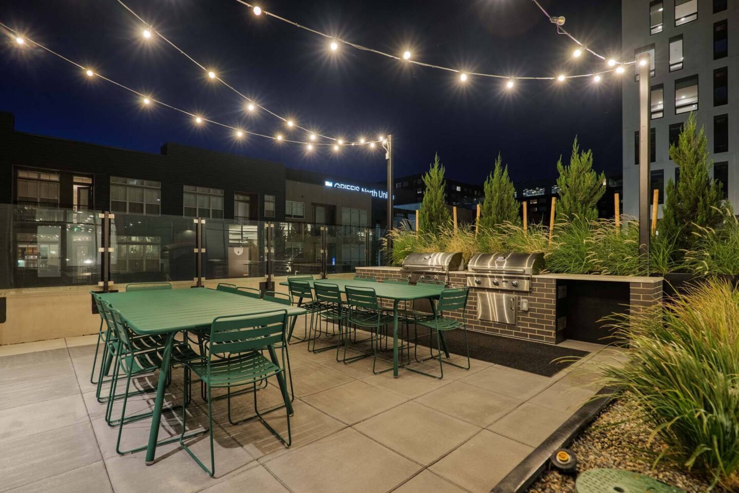 A patio with tables and chairs under string lights at Windsor 3000 Huron, 3000. N. Huron Street, Denver, CO 80202.