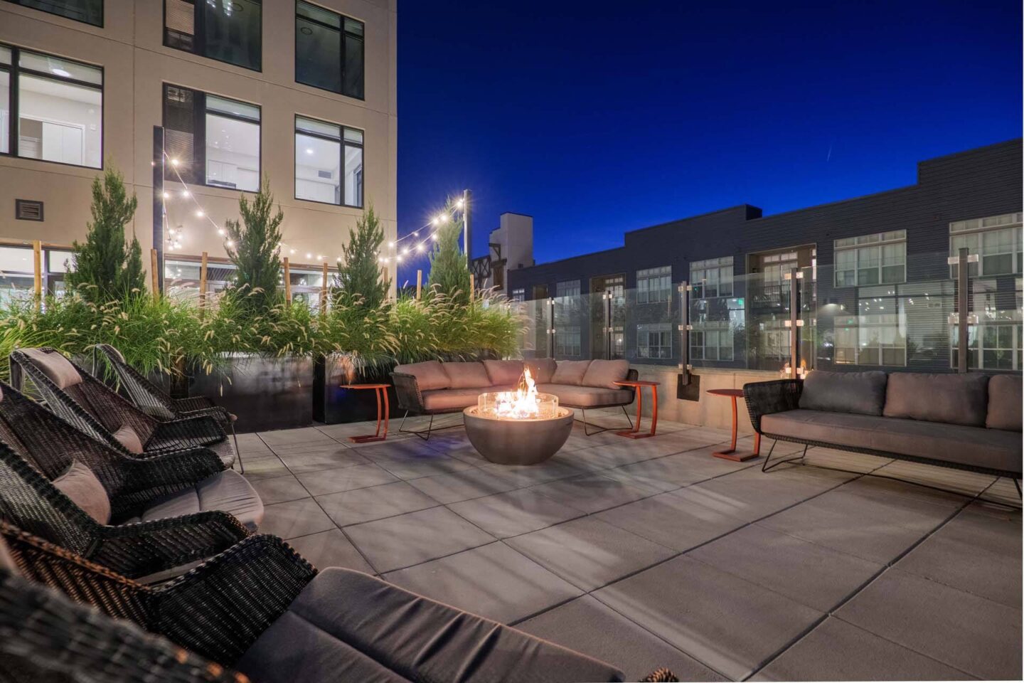 A patio with a fire pit and seating area at Windsor 3000 Huron, 3000. N. Huron Street, Denver, CO 80202.