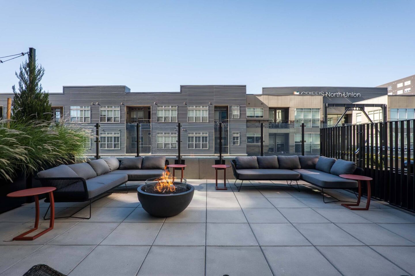 A modern outdoor seating area with a fire pit in the center at Windsor 3000 Huron, 3000. N. Huron Street, Denver, CO 80202.