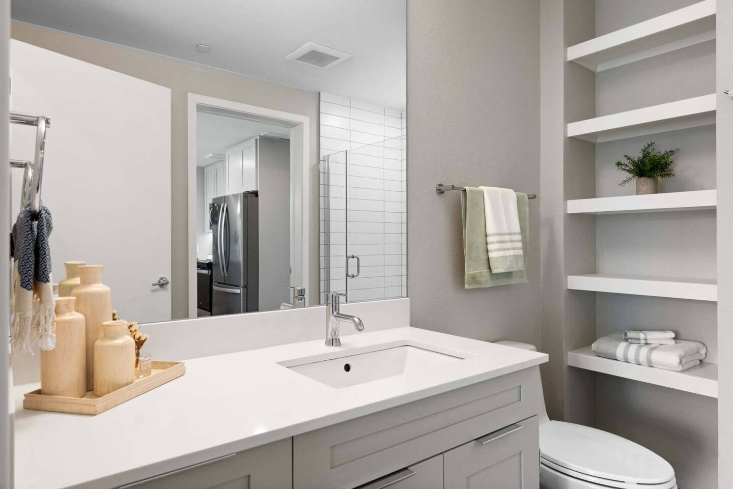 A modern bathroom with a white counter top and shelves at Windsor 3000 Huron, 3000. N. Huron Street, Denver, CO 80202.