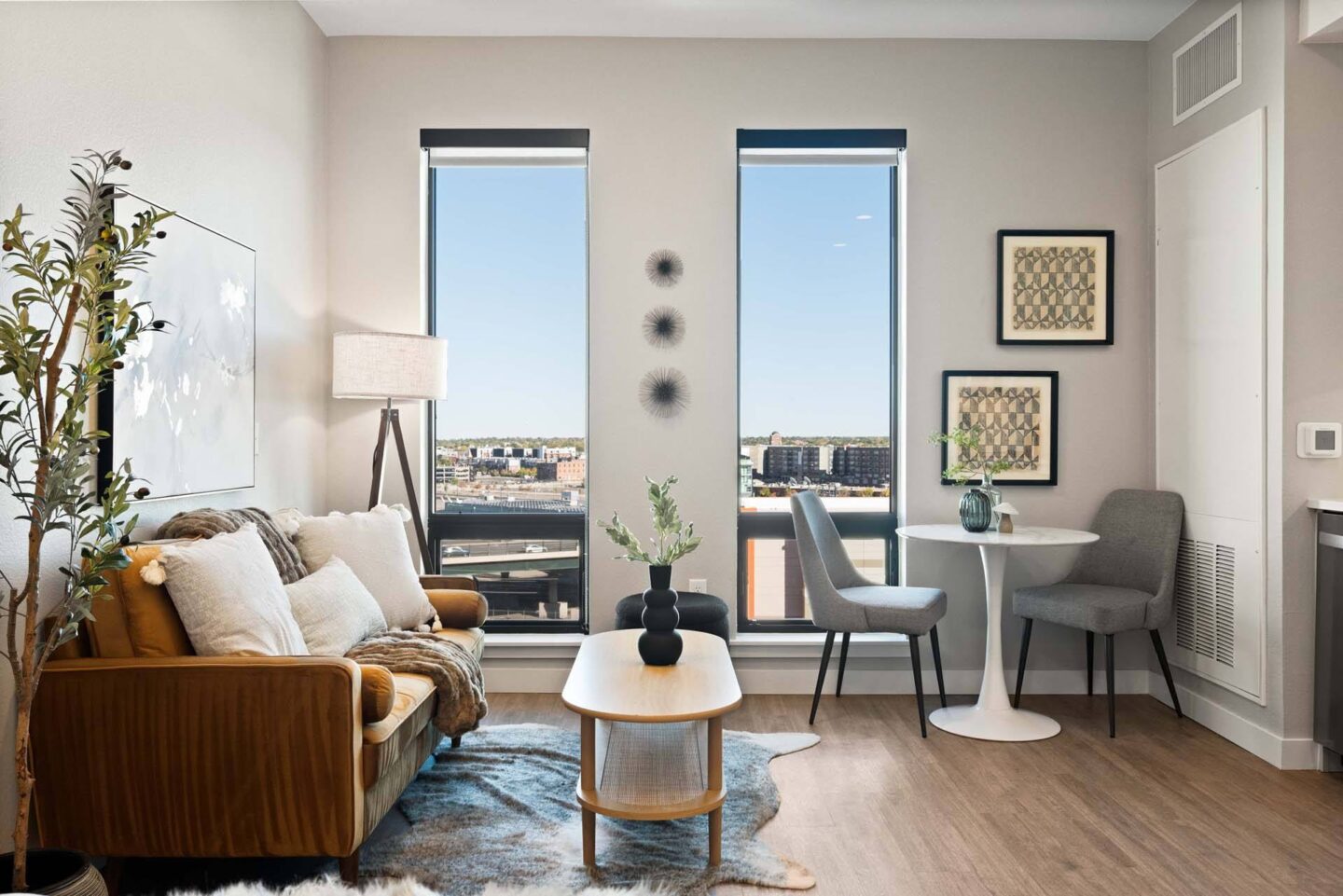 A living room with a view of the city at Windsor 3000 Huron, 3000. N. Huron Street, Denver, CO 80202.